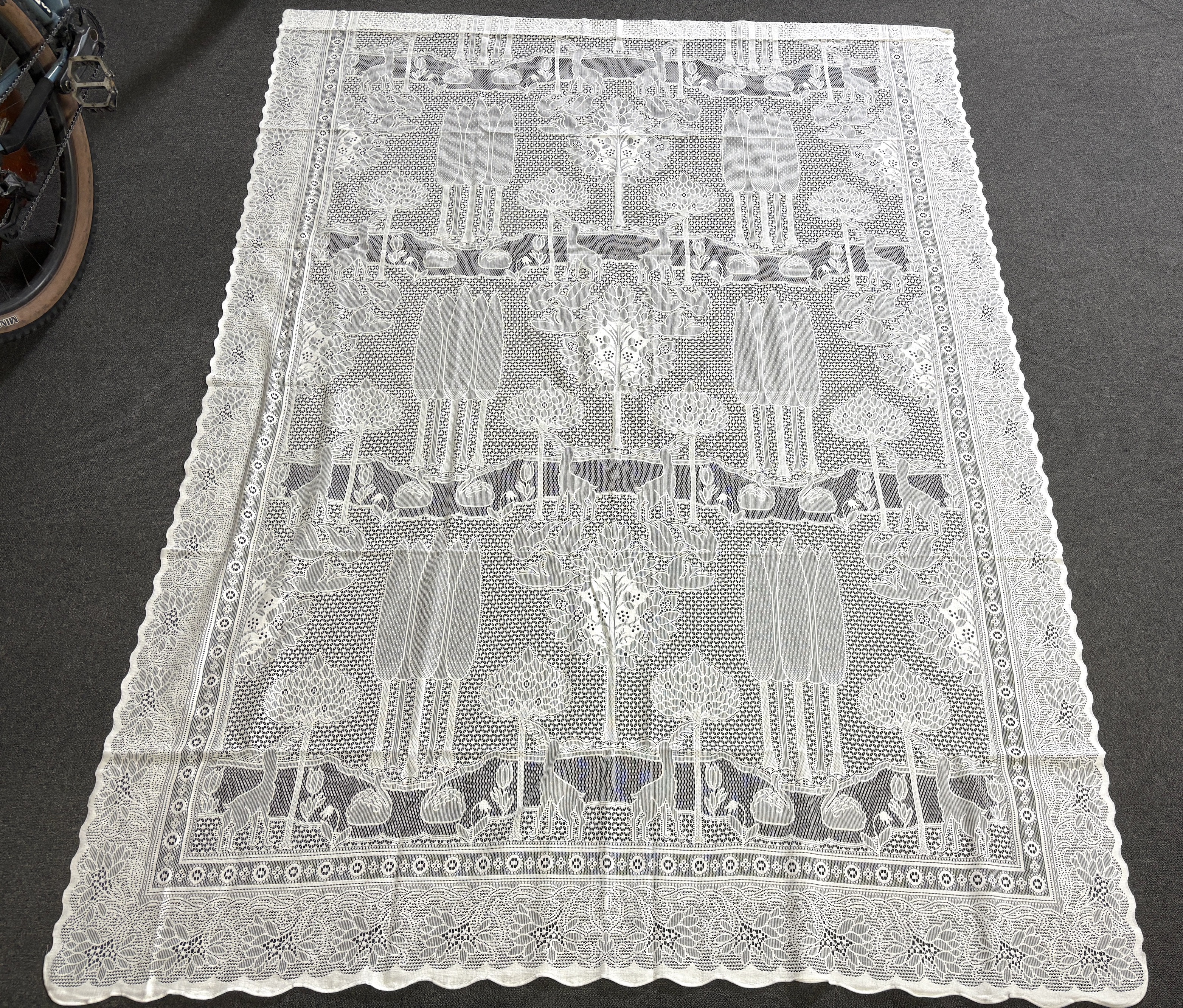 A set of three C.F.A. Voysey design “The Stag”, machine made, cotton lace curtains manufactured by Rose’s Mill Ltd, Ayrshire, unused, 180cm x 240cm